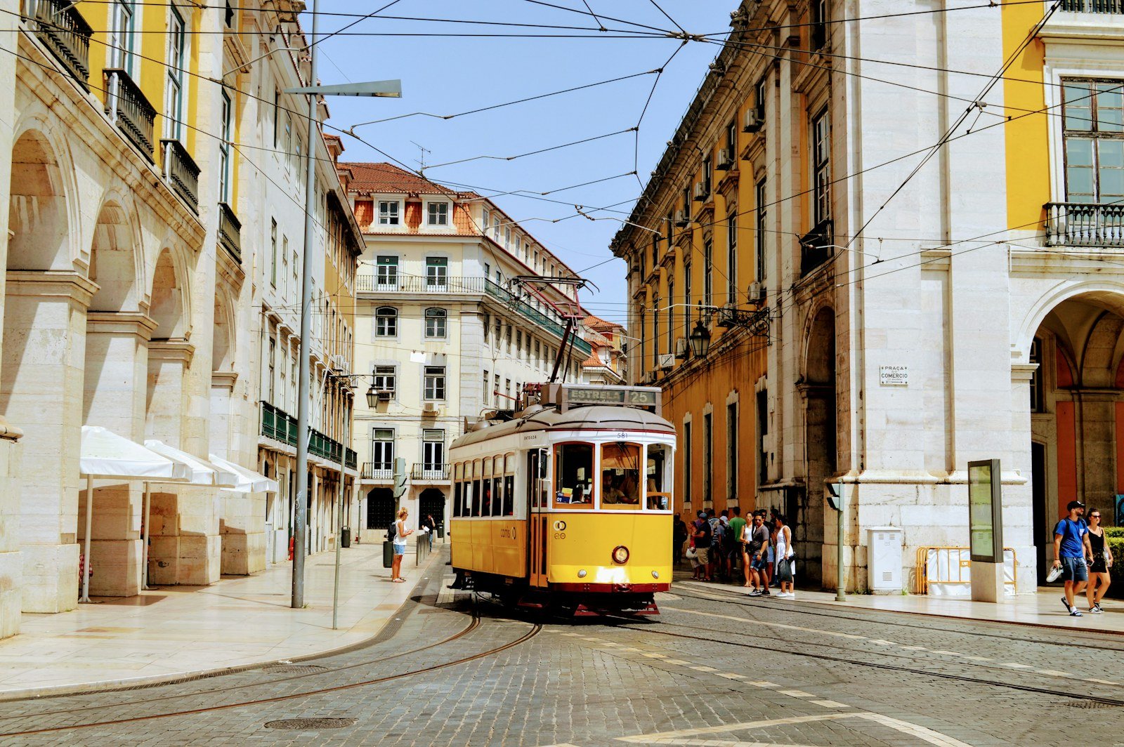 Yellow tram on a historic street in Lisbon