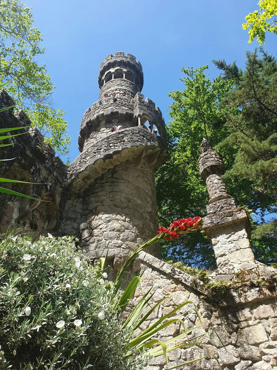 Stone garden tower among trees at Quinta da Regaleira in Sintra